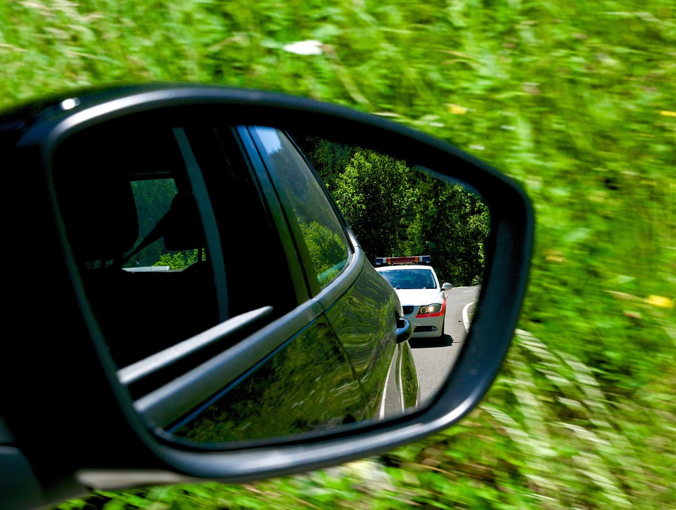 Picture of a car getting pulled over for the blog about how speeding tickets affect insurance.