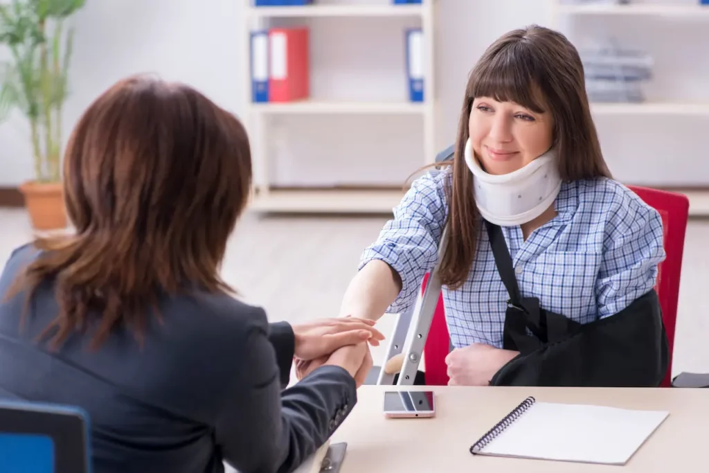Picture of an injured woman consulting her personal injury lawyer asking how much to claim in a personal injury settlement in North Carolina