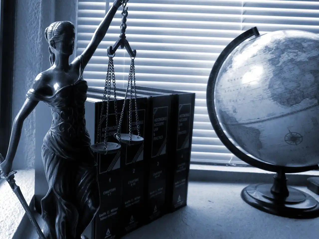 Picture of a desk in a law office with a globe and books for the web page about Fayetteville car accident lawyers.