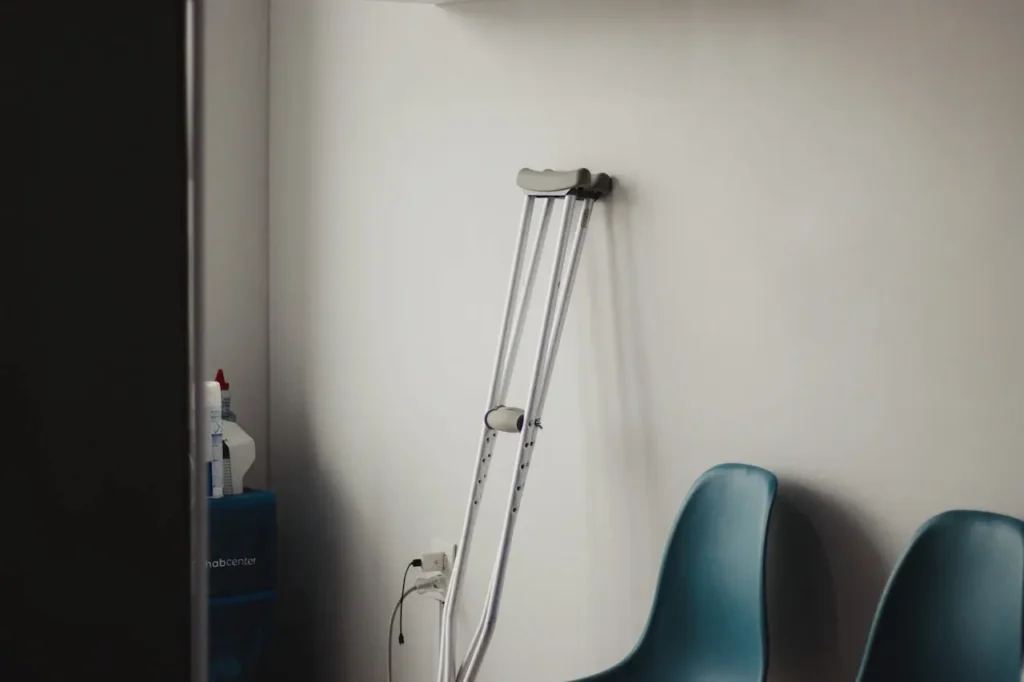 Picture of crutches leaning up against a wall in a hospital for the North Carolina worker's compensation lawyer service page.