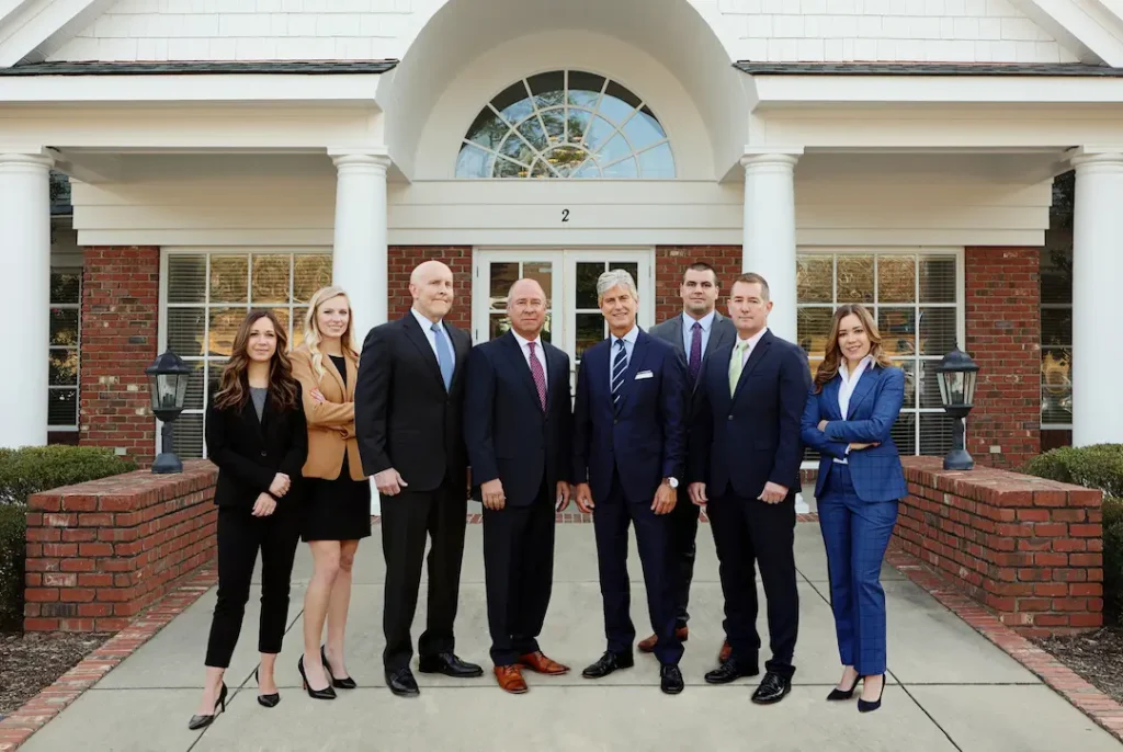 Picture of the attorneys in front of the Van Camp, Meacham & Newman law firm in North Carolina.