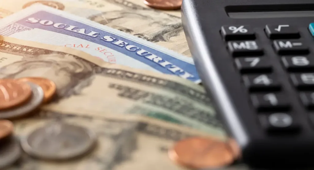 Picture of money and a social security card for the article about conditions that qualify for disability benefits in North Carolina.